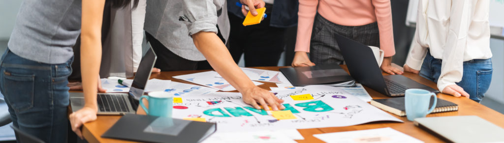 People working on developing a brand on a table