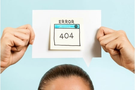 Person holding a card that says 404 error