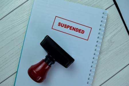 A stamp on a piece of paper saying "suspended"