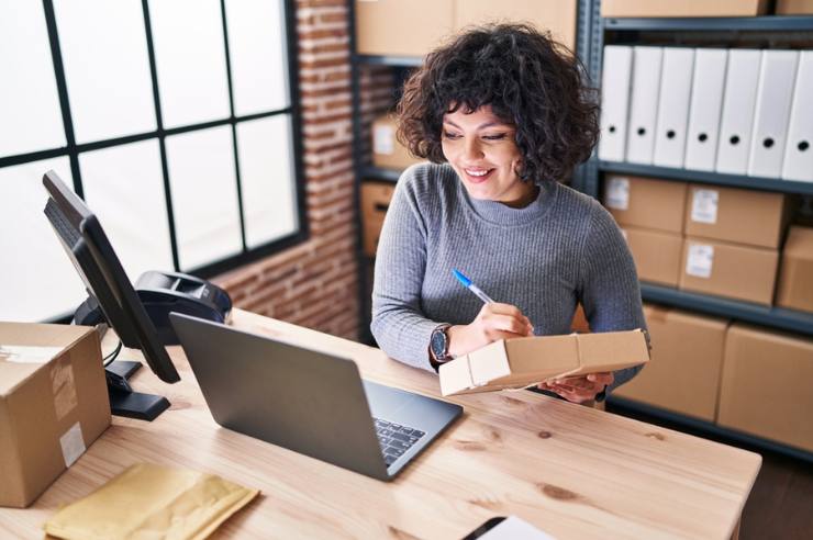 Business owner reviewing eCommerce replatforming checklists on a laptop