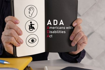 A lawyer holding a book on ADA website compliance