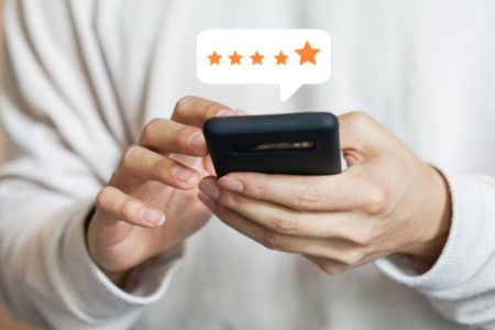 Customer providing a 5-star review on their phone