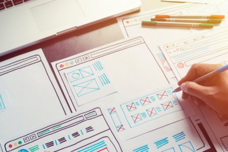 Person developing wireframes for a clean website navigation