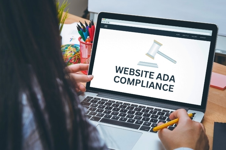 woman reading laptop researching do websites have to be ada compliant