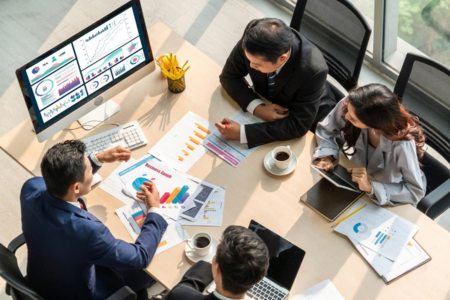 Members of a digital marketing agency reviewing charts