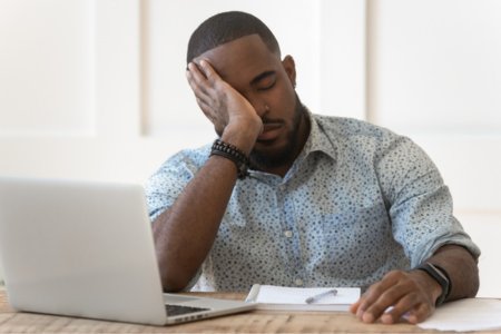 Upset person at a laptop after being frustrated with Squarespace SEO