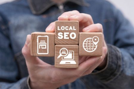 Hands holding blocks with local SEO text