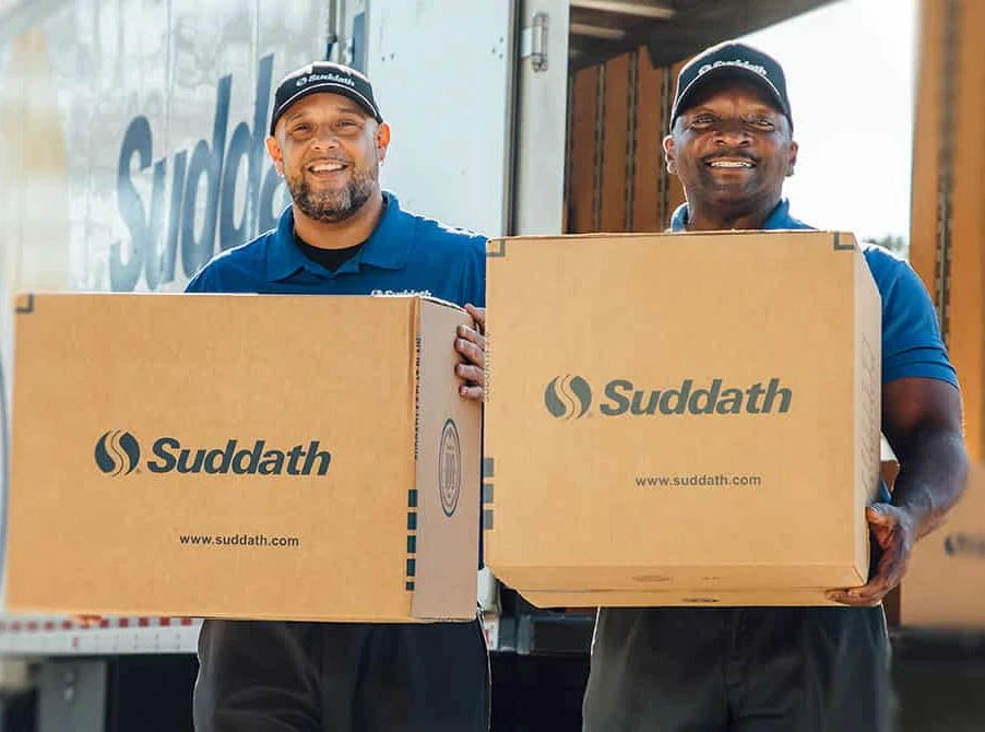 Two Suddath employees carrying boxes