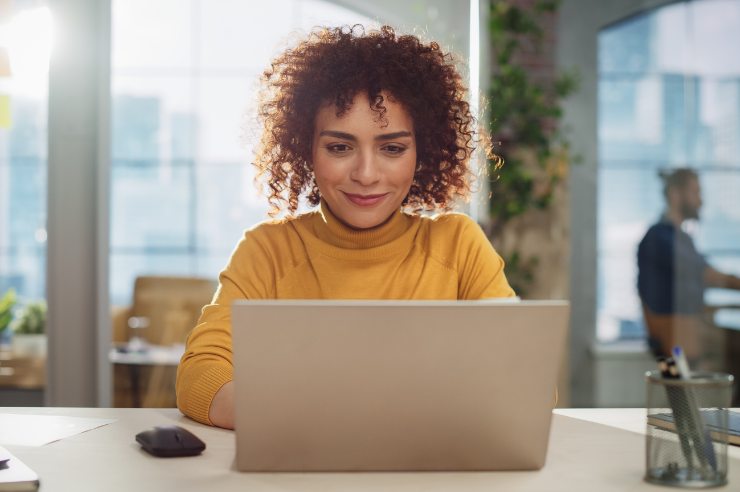 A person on a laptop setting up a Shopify store.