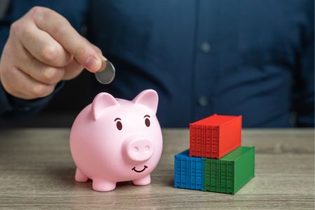 Man putting coin in a piggy bank