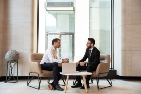 two men sitting talking about a strategy