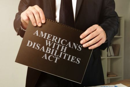 Lawyer holding an ADA book.