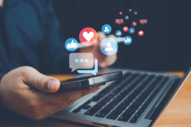 social media icons popping out of the phone.