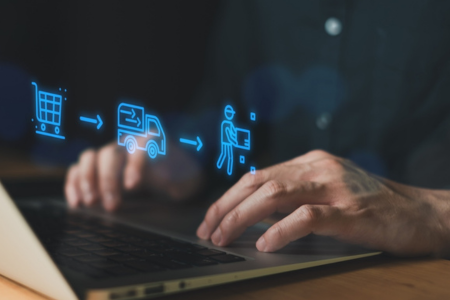 Man on a computer with e-commerce visualization.