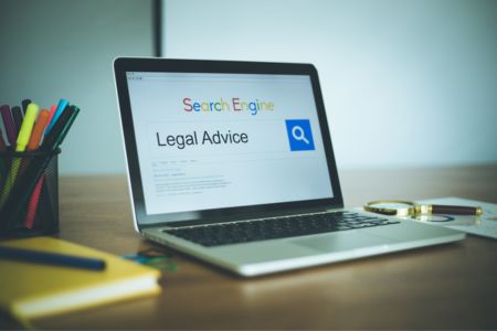 Computer with legal advice displayed on screen.