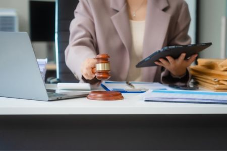 Lawyer at desk with gavel.