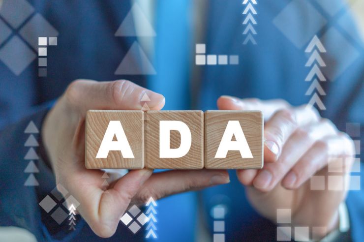 Man holding wood blocks with ADA letters.