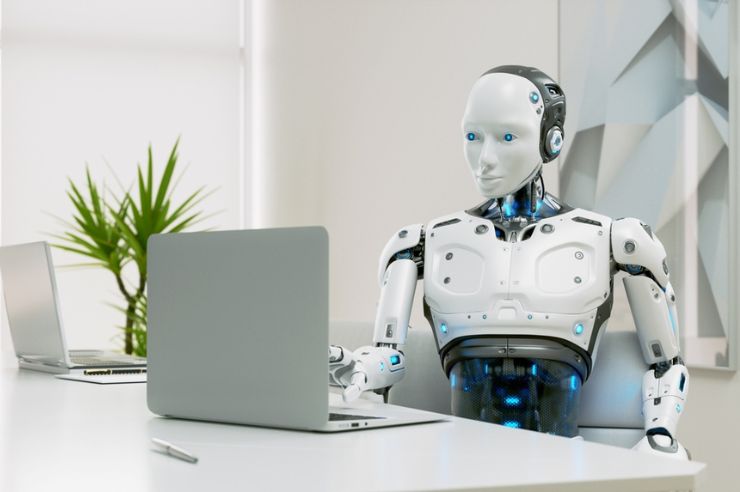 Robot working on a computer.