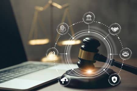 Computer and gavel with marketing visualizations.