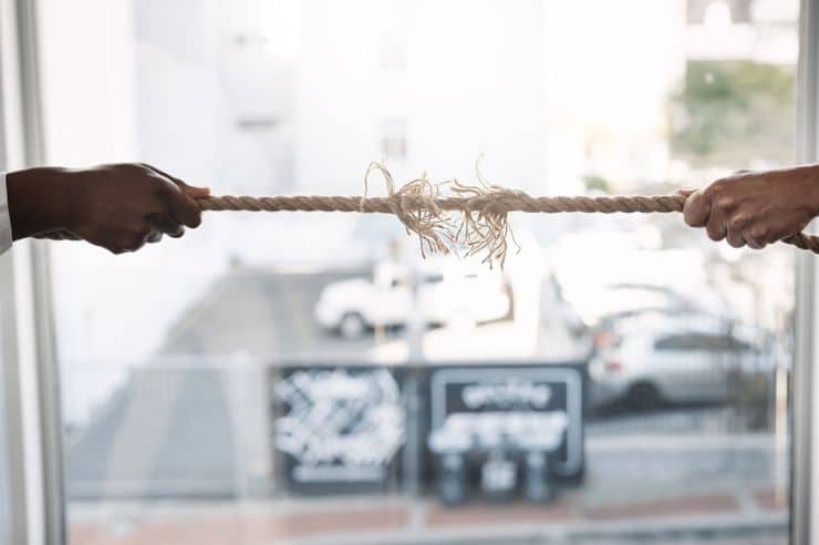 business people pulling a rope in a challenge