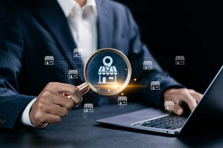 Businessman using a magnifying glass to find the Local Service Ads logo