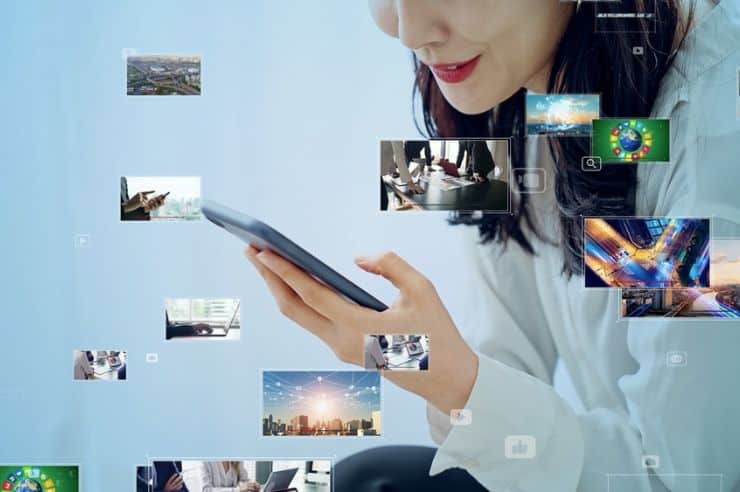 Woman viewing a variety of videos on her phone.