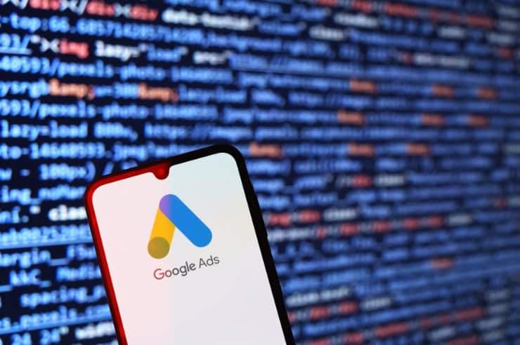 A mobile phone displaying the Google Ads logo.