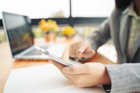 businessman taking notes on his phone