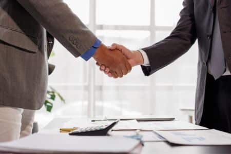 businessmen shaking hands over a deal