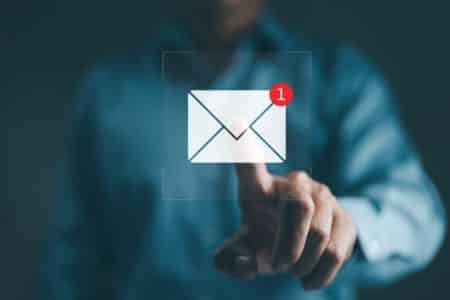 hand tapping email notification icon on screen.