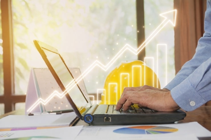man typing on laptop looking at home marketing trends with graphic overlay