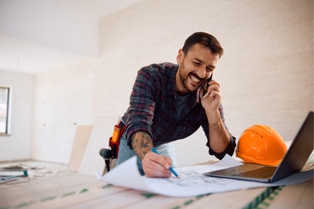 home services business owner on phone and working
