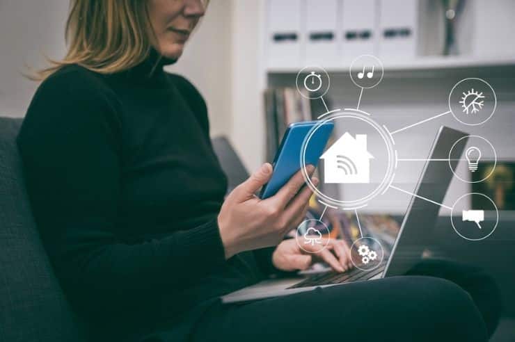 business owner managing social media marketing on a smartphone and a laptop.