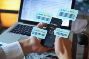 business owner viewing online business reviews and ratings on smartphone.