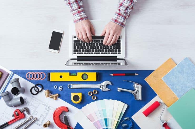 Home services SEO marketing workspace with laptop and professional contractor tool